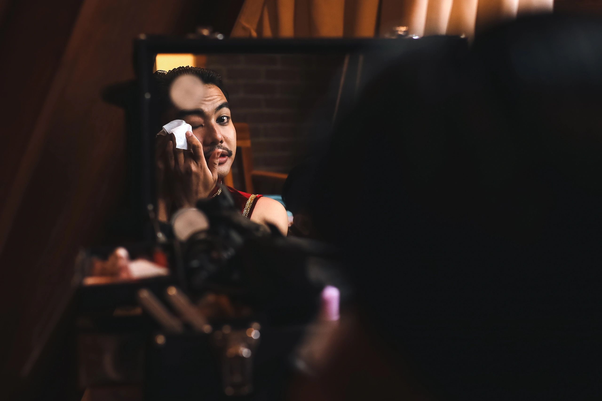 Young Male Dancer Wiping His Face with Tissue
